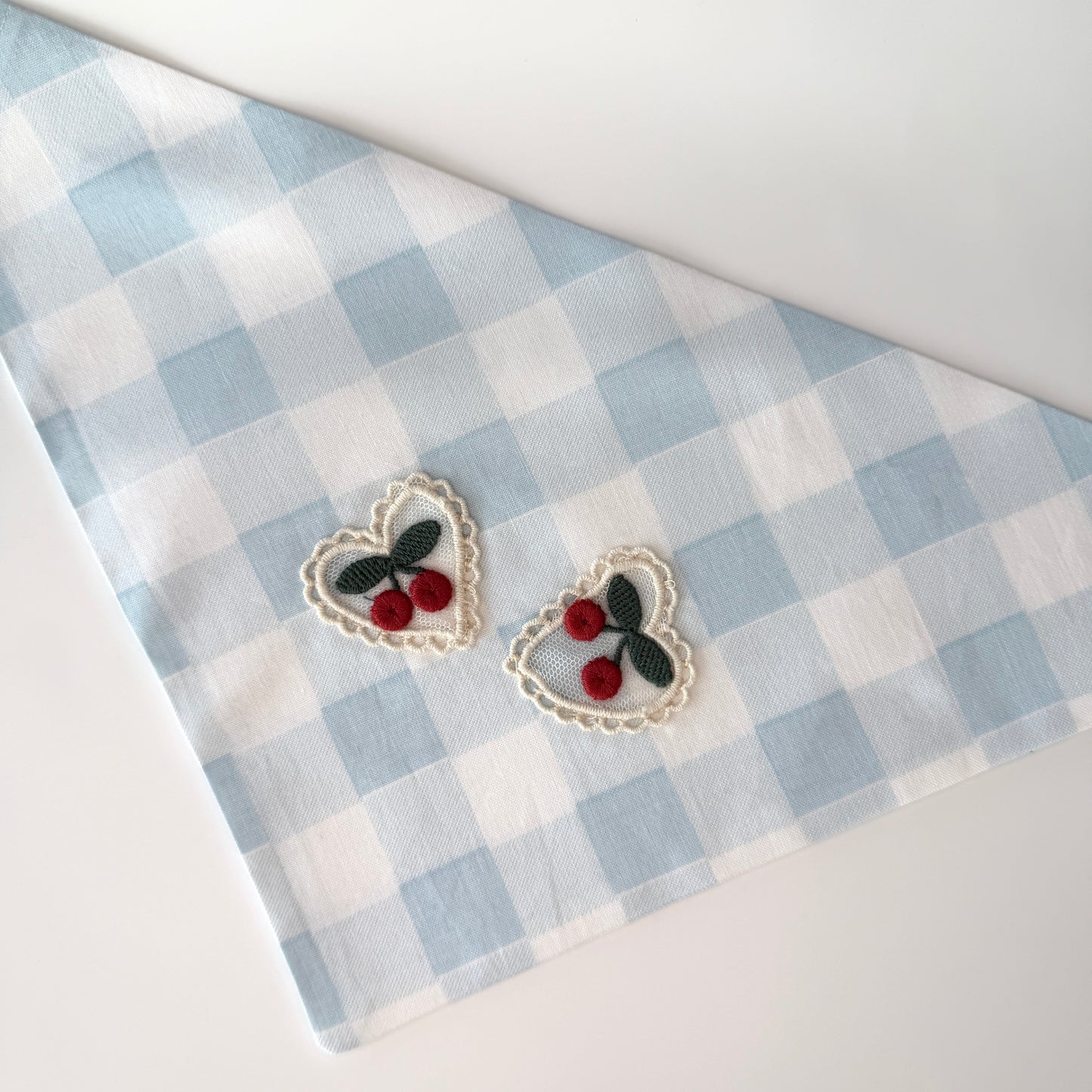 Large size light blue and white checkered cotton bandana with a heart design featuring cherries on a white background