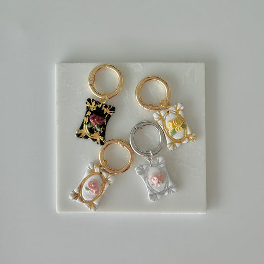 Four Rectangle pet id tags each with 3 roses and silver or gold leaf gilding on a white marble background
