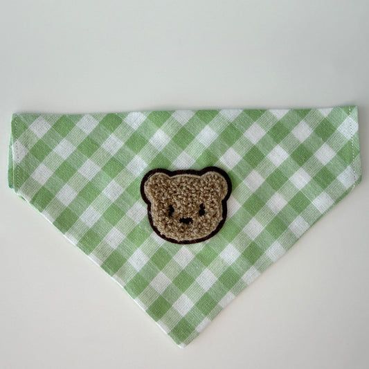 Green and white checkered bandana with a bear patch on a white background