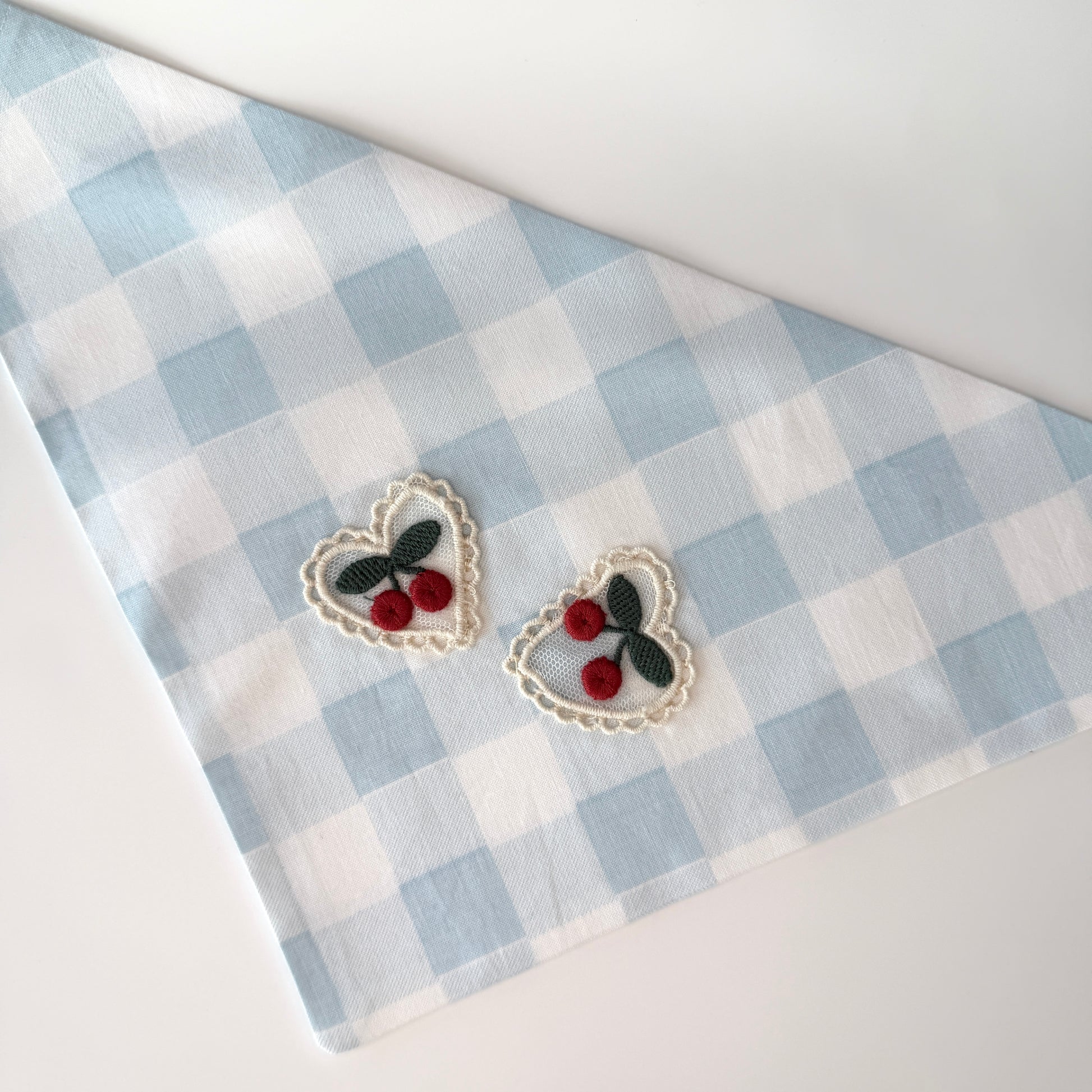 Large size light blue and white checkered cotton bandana with a heart design featuring cherries on a white background