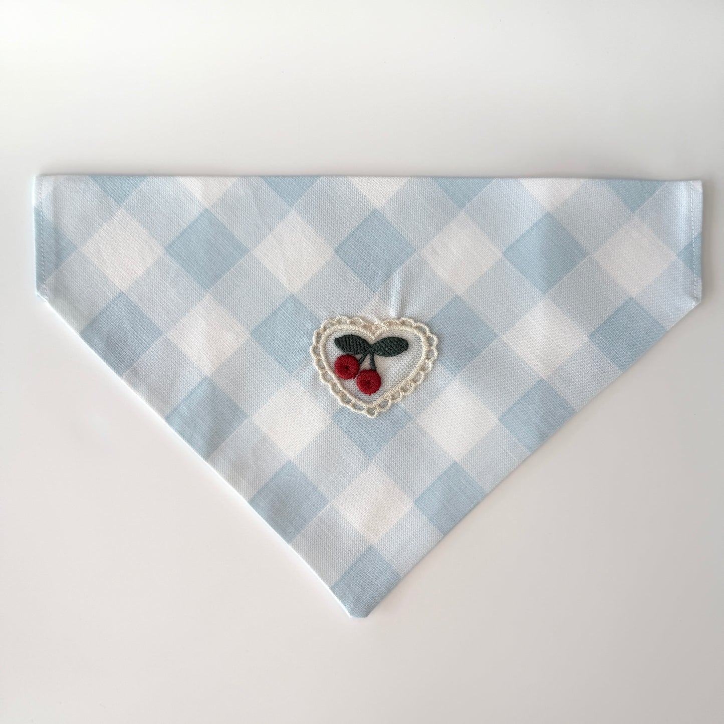 Medium size light blue and white checkered cotton bandana with a heart design featuring cherries on a white background