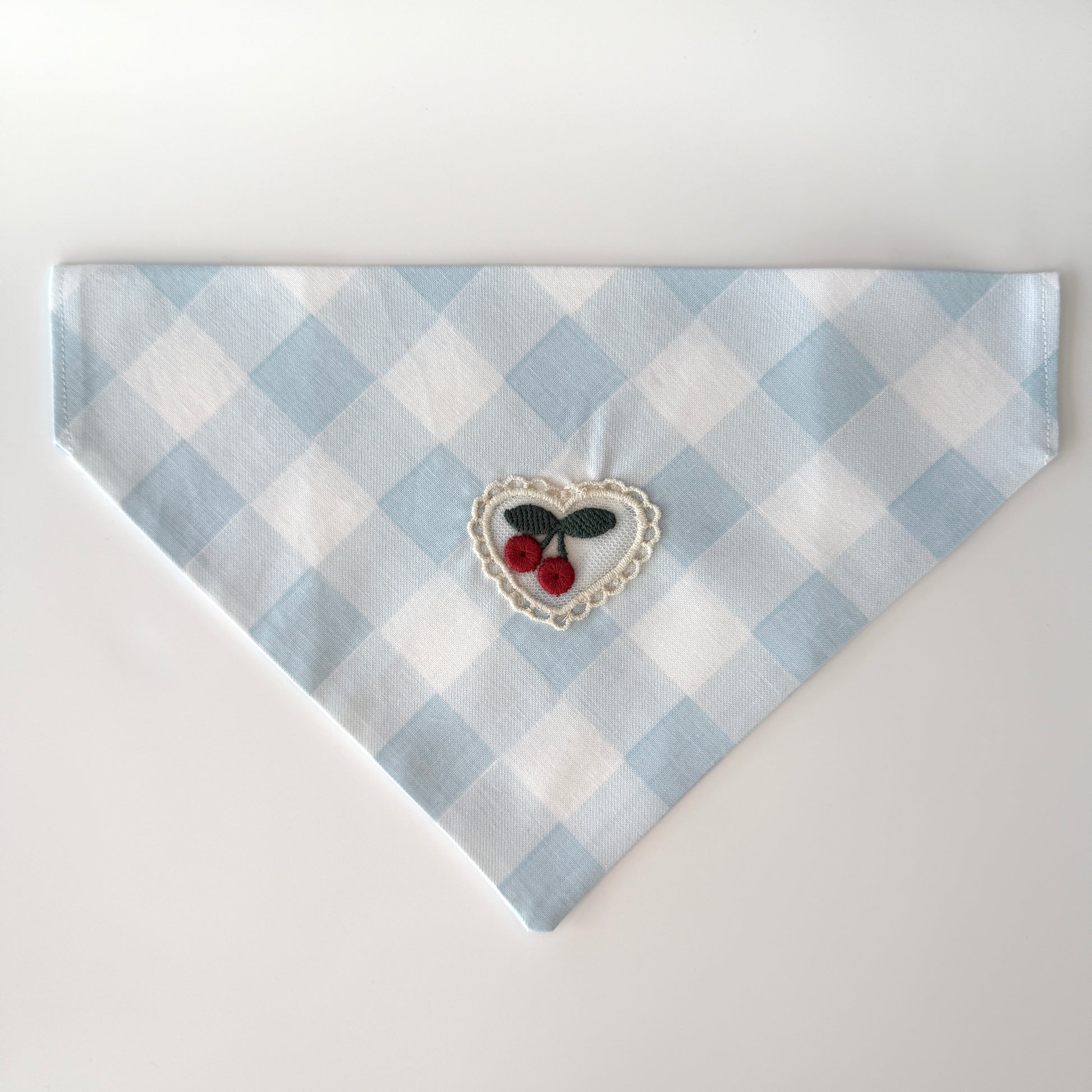 Medium size light blue and white checkered cotton bandana with a heart design featuring cherries on a white background