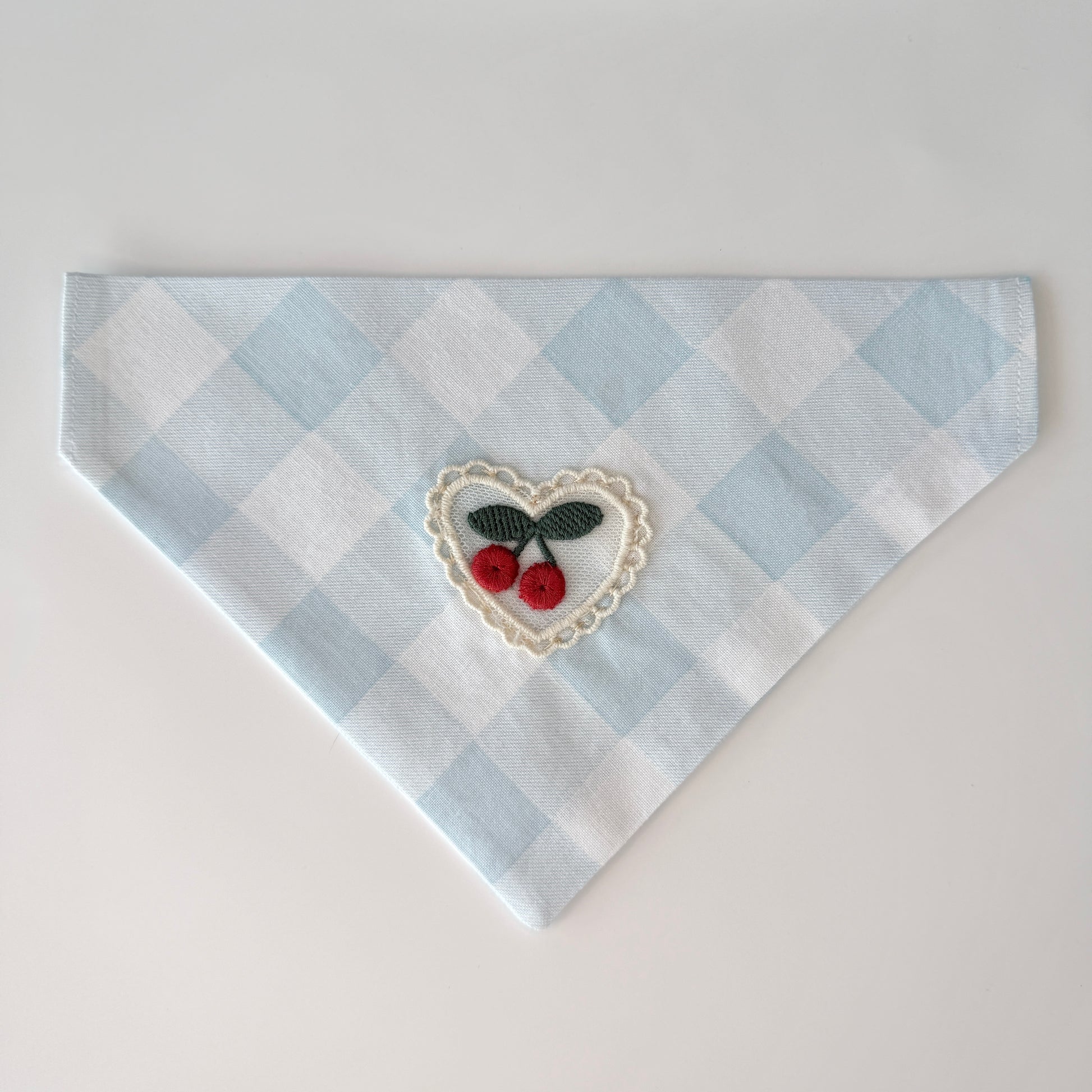 Small light blue and white checkered cotton bandana with a heart design featuring cherries on a white background