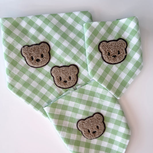 Green and white checkered gingham cotton bandanas with embroidered bear faces on a white background