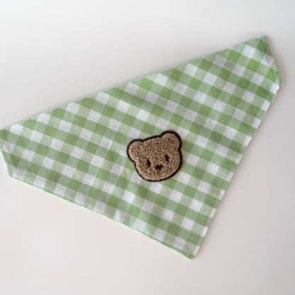 Green and white checkered bandana with a brown teddy bear patch on a white background