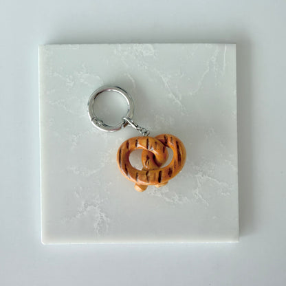 back of a polymer clay fake food soft pretzel charm with grill marks