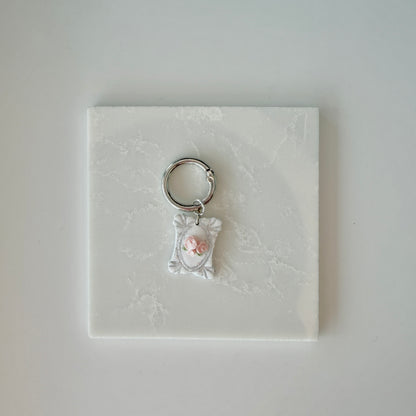 Rectangle pet id tag with 3 pink roses and silver engraving on a white marble background