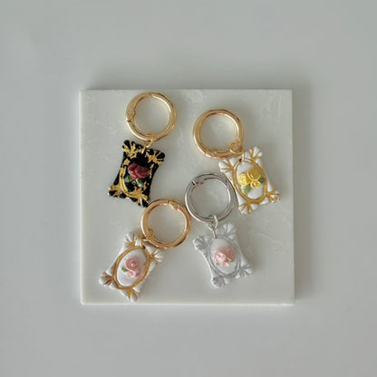 Four Rectangle pet id tags each with 3  roses and silver or gold leaf gilding on a white marble background