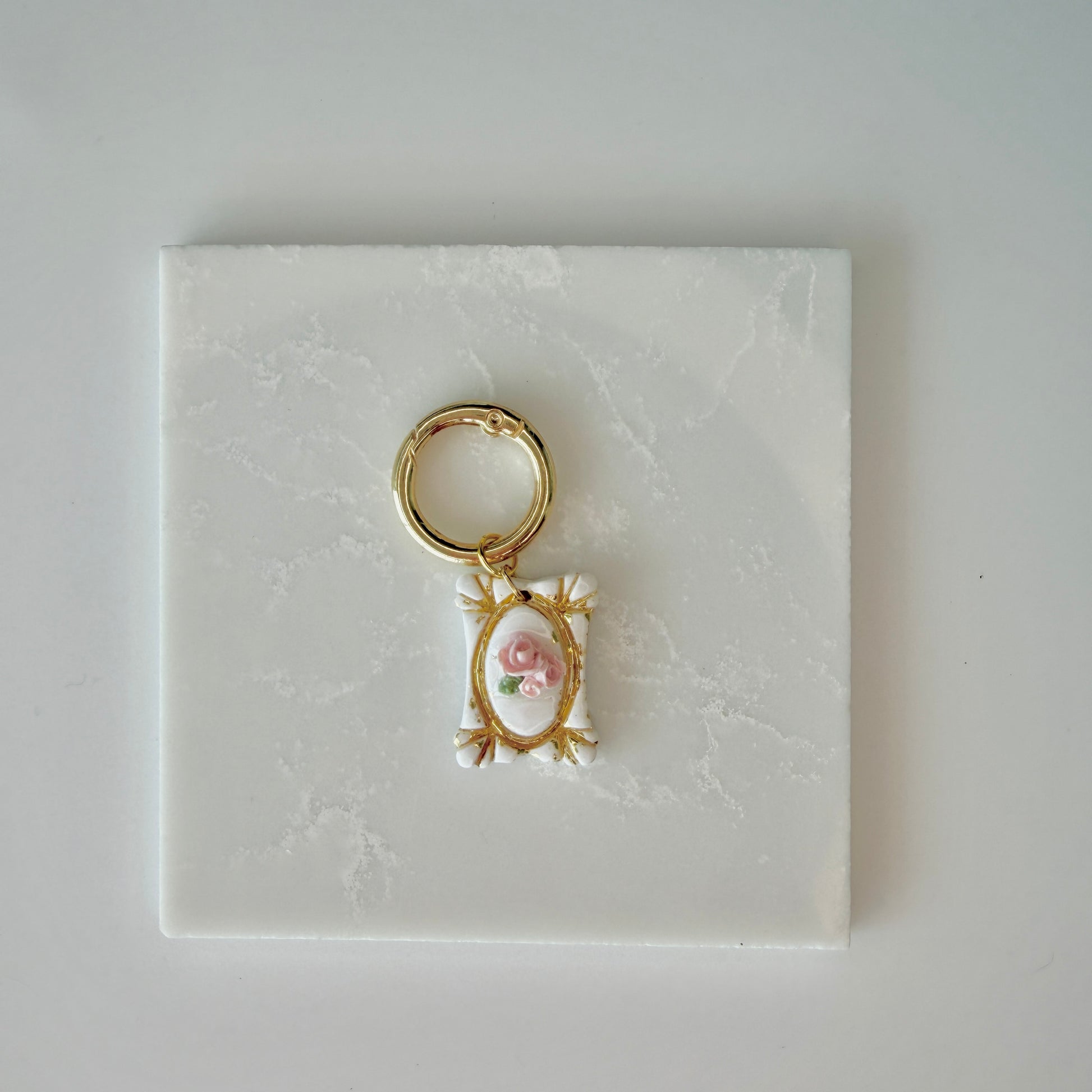 Rectangle pet id tag with 3 pink roses and gold engraving on a white marble background