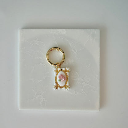 Rectangle pet id tag with 3 pink roses and gold engraving on a white marble background