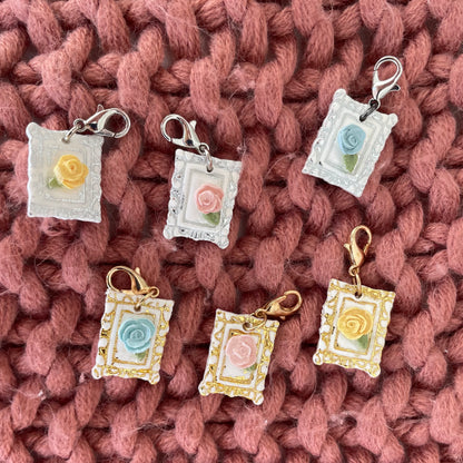 Decorative charms with floral designs on a knitted fabric background